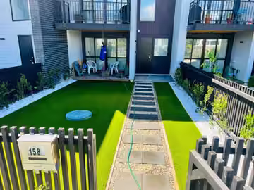 Artificial lawn and stepping stones in a New Lynn side garden