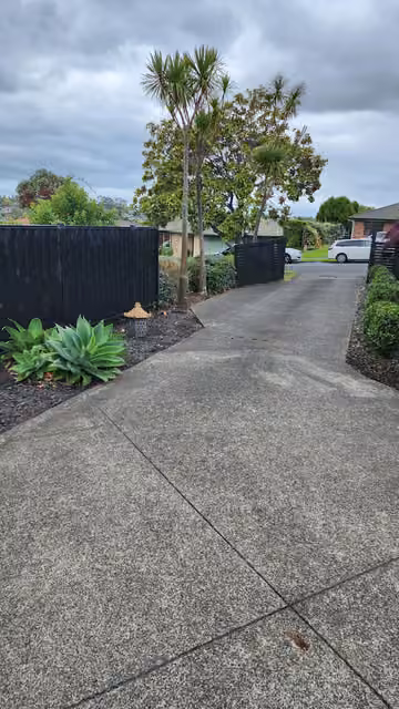 Customer photo of a tidy driveway and garden border